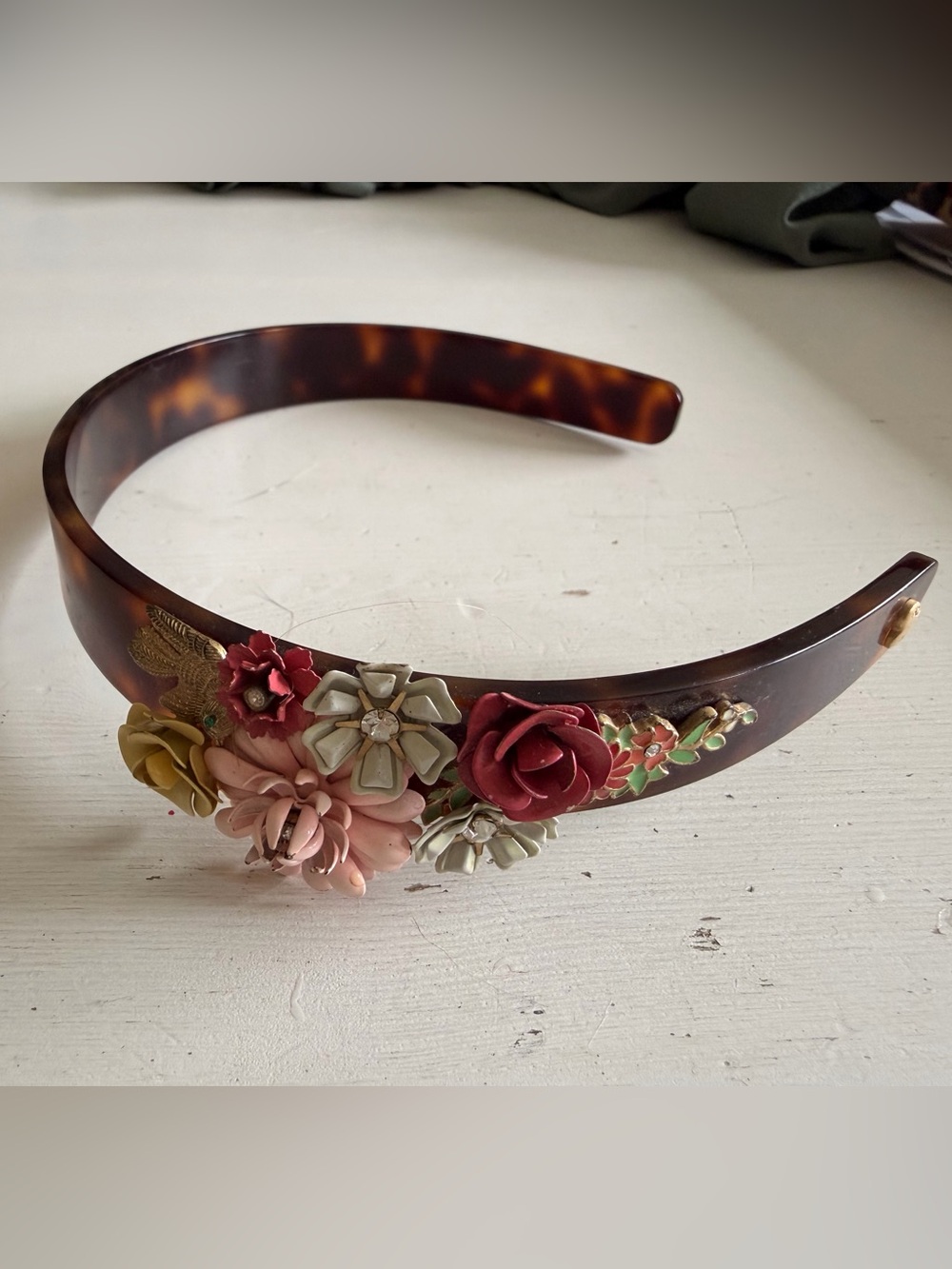 Juicy tortoiseshell headband with floral and bird accent pieces attached